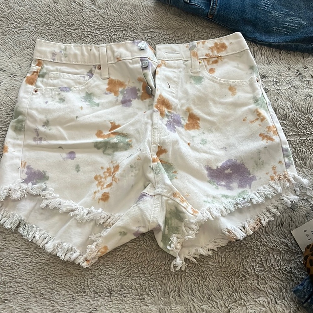 White shorts with orange and green and lavender prints